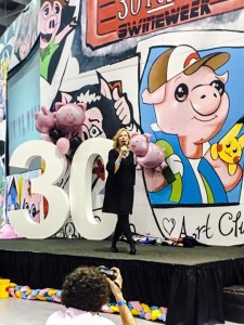 Barbara speaking at a Swine Week assembly.